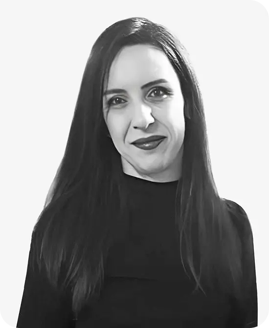 Professional headshot of a woman with long dark hair wearing a black top, smiling slightly.